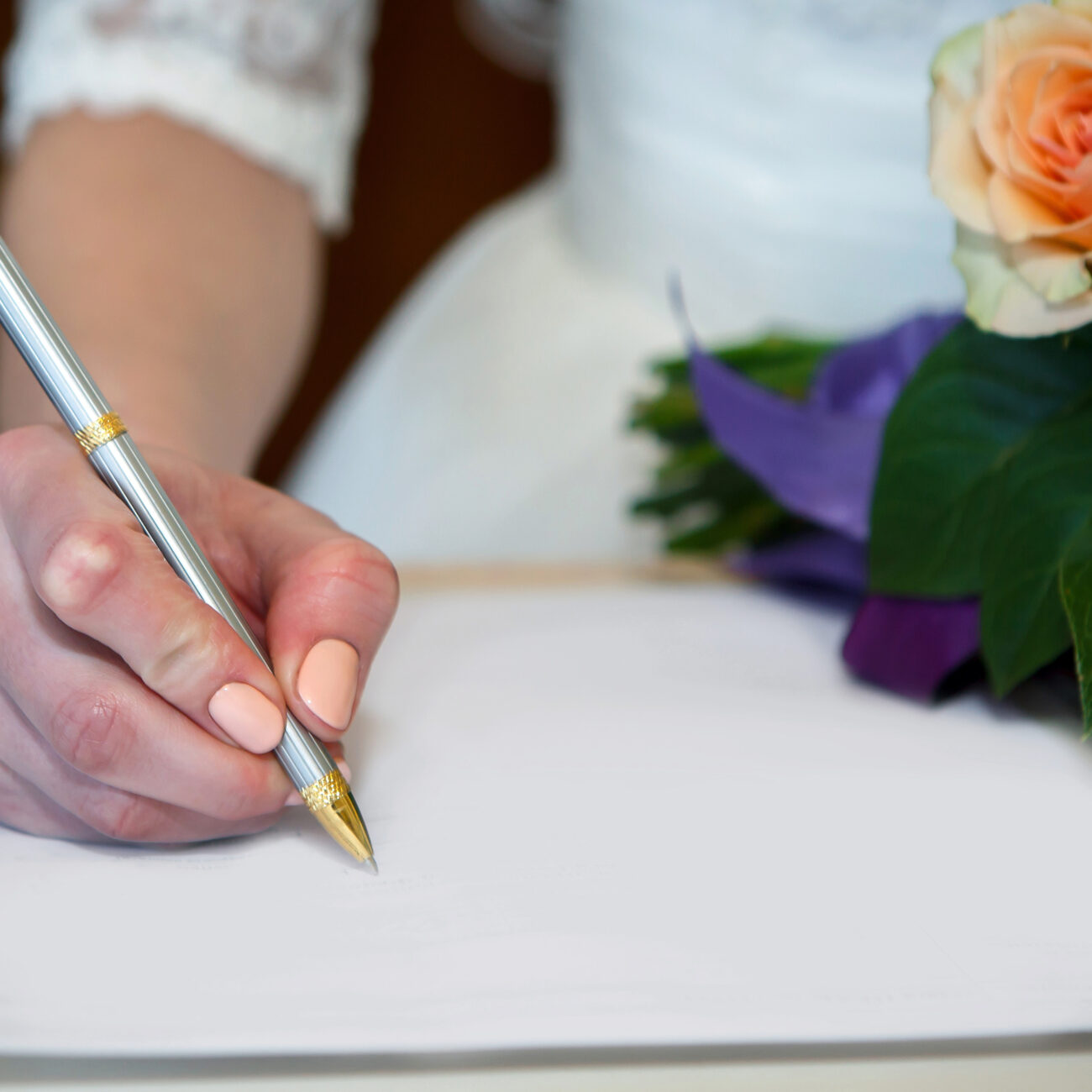 Hand,Of,The,Bride,Signing,The,Marriage,Contract,On,Paper